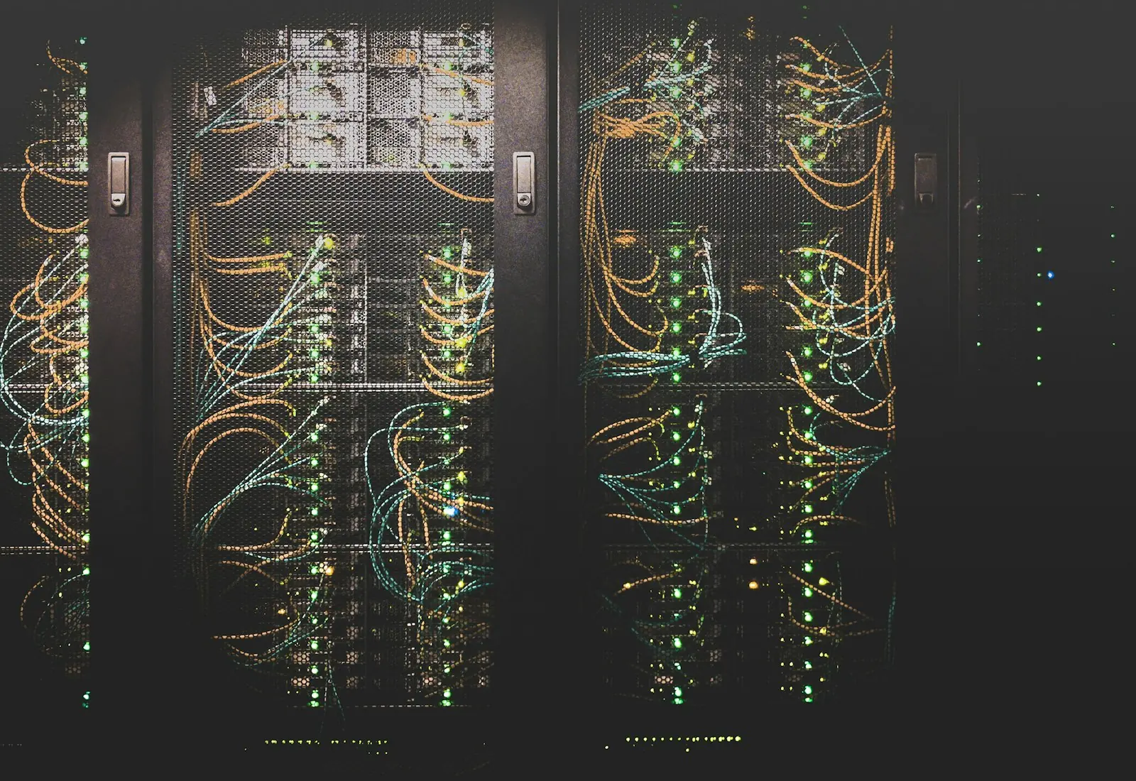 Server racks in a dim data center with status lights