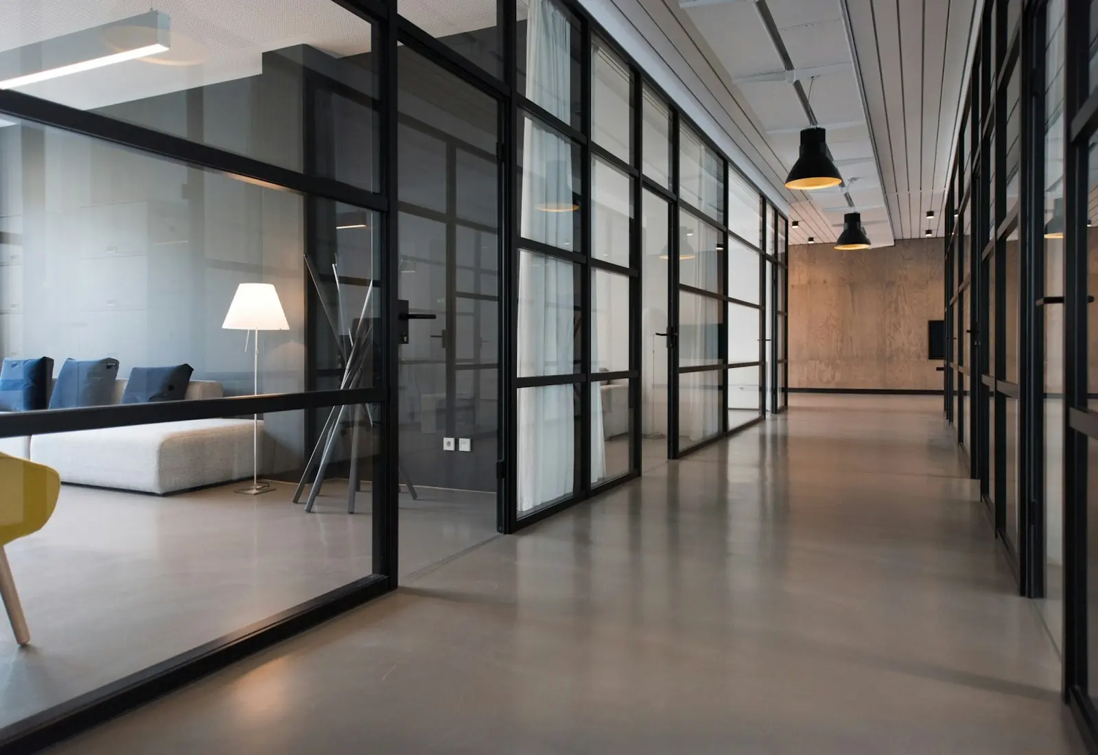 A bright office with glass walls and meeting rooms