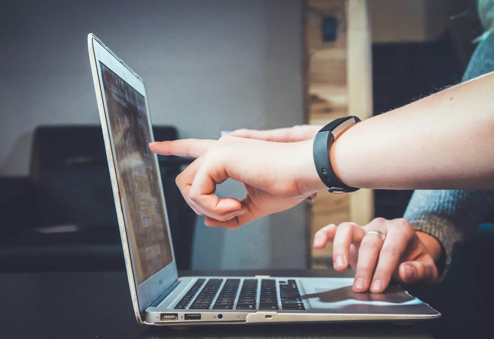 Hands working on a laptop during a review